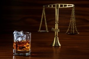 alcohol next to scales of justice