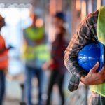 construction worker holding a blue hard hat