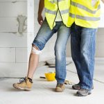 a worker helps another injured worker walk after an injury